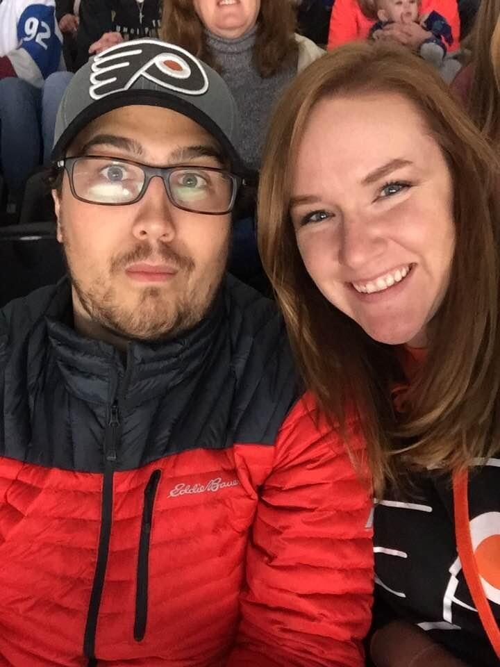 Robert asked Laura to be his girlfriend at a Flyers game. 