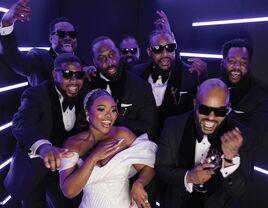 Bride and wedding guests posing in photo booth