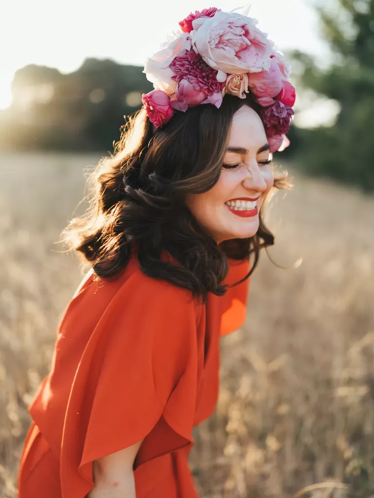 Bride Smiling in a Field While Wearing Pink Flower Crown