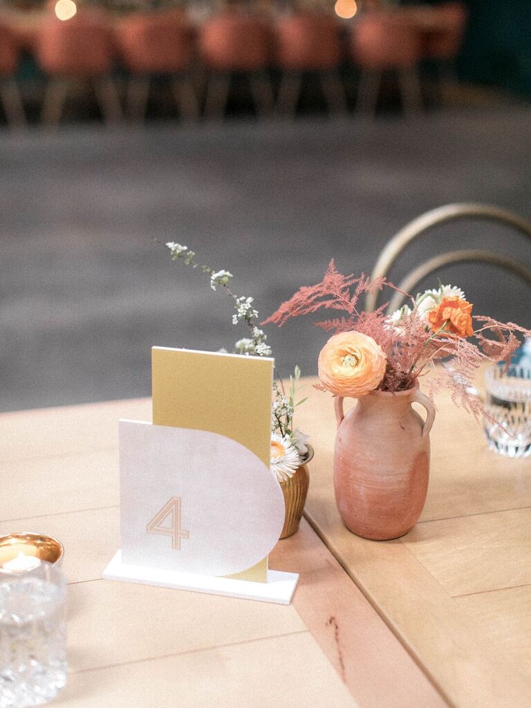 Clay urn vases with florals and table number