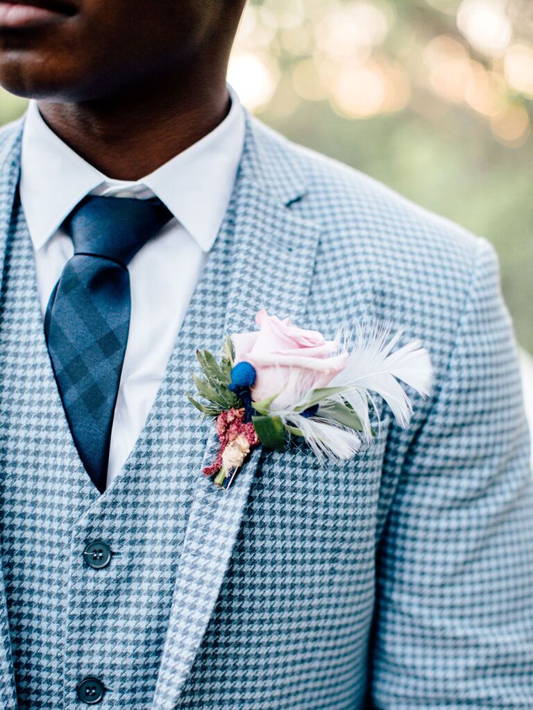 Groom wearing pastel pink floral boutonniere and blue houndstooth suit