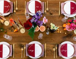 Wood farm table with purple place settings