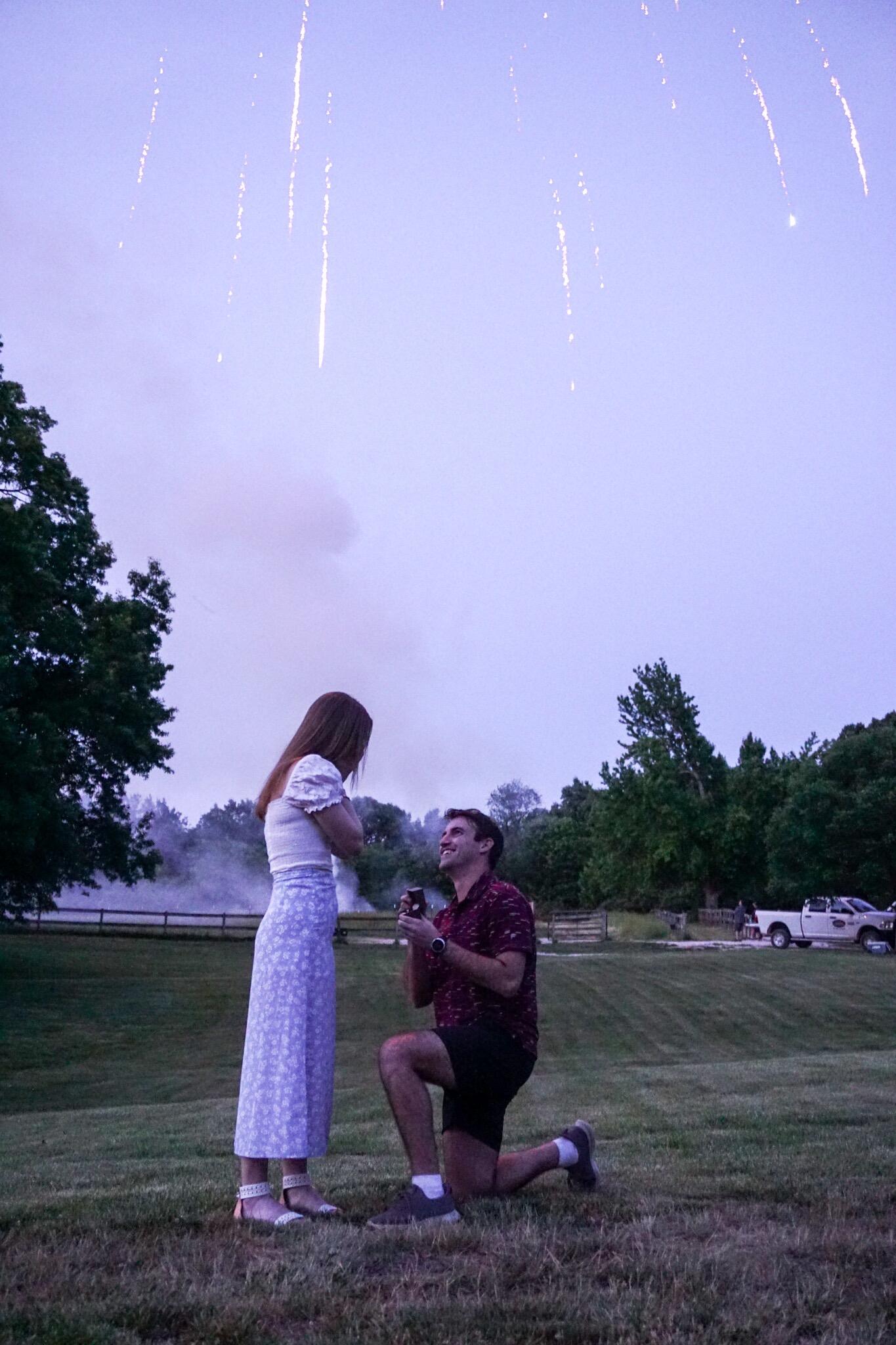 On May 28th, 2023, Carson proposed to Jenny under fireworks at his family’s country club Memorial Day Weekend party.  Both of their families were present to celebrate and experience this once-in-a-lifetime moment together. 
