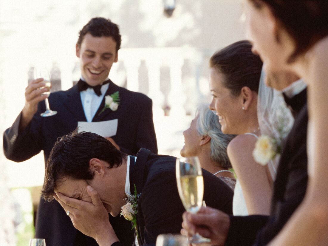 Best man giving embarrassing speech at wedding reception