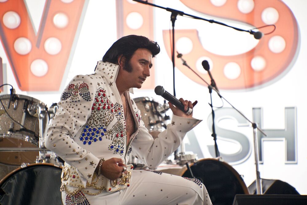 elvis impersonator singing on stage