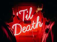 Neon sign saying 'til death' at wedding