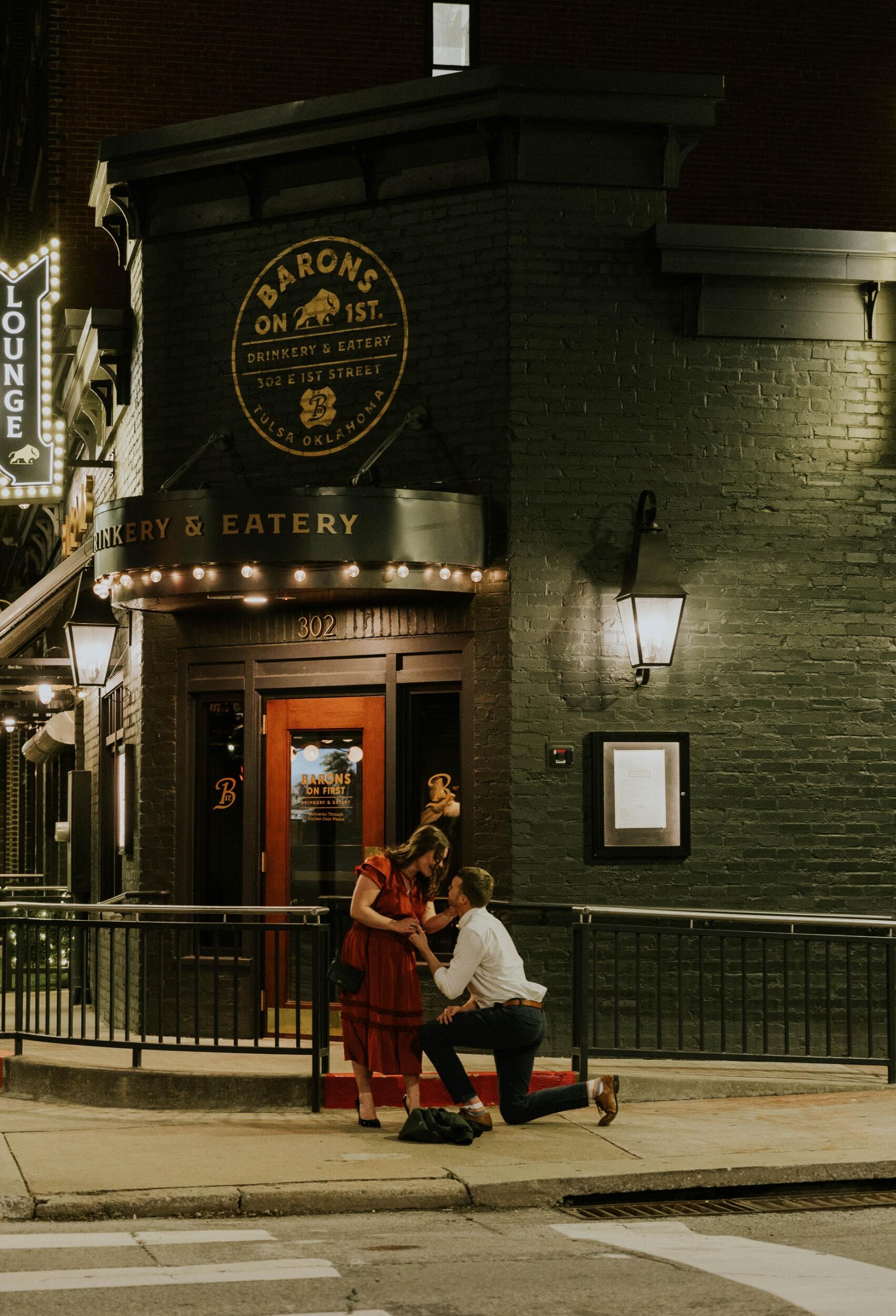 On February 8th, 2025, TJ and Megan went out for "fancy dinner" which they like to do a couple of times a year. This fancy dinner took place at Baron's on 1st. The meals were delectable and the service was top-notch. Upon leaving the restaurant, TJ dropped to one knee and proposed. Of course, Megan said "Yes!" TJ had hired a photographer to sneakily document the whole night, even while they were eating! They were presented with champagne and a chorus of congratulations.  It was the best night of their life (so far). 
