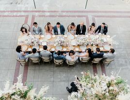 Guests eating meal around table outside