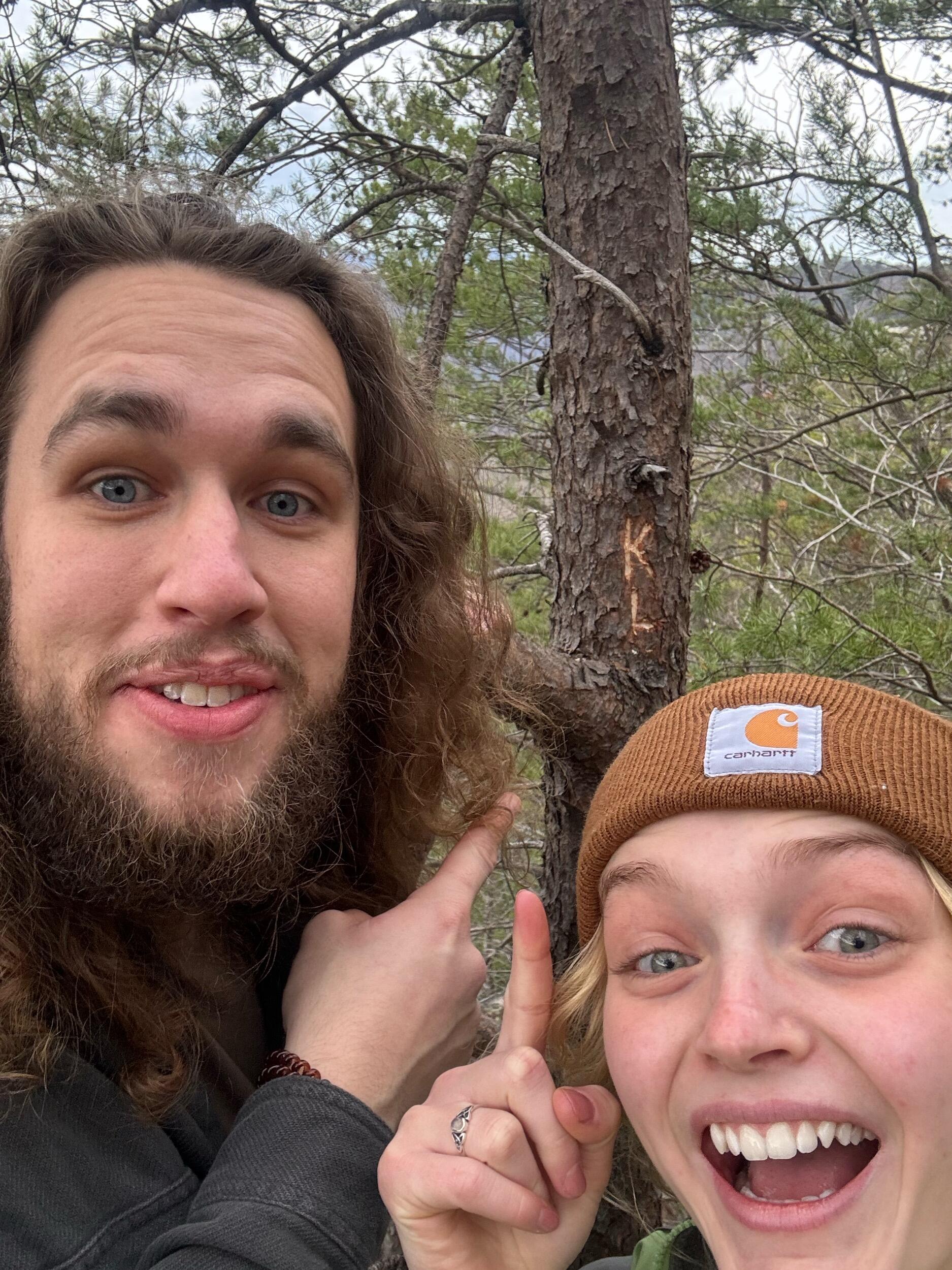 Carved our names into a tree on a hike in WV!