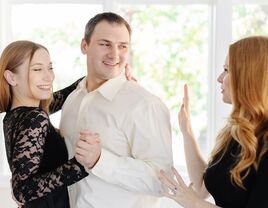 Dance instructor helping couple with their first dance