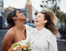 Couple on wedding day smiling and laughing together