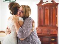 A bride and her mother share a tender moment together on the big day.