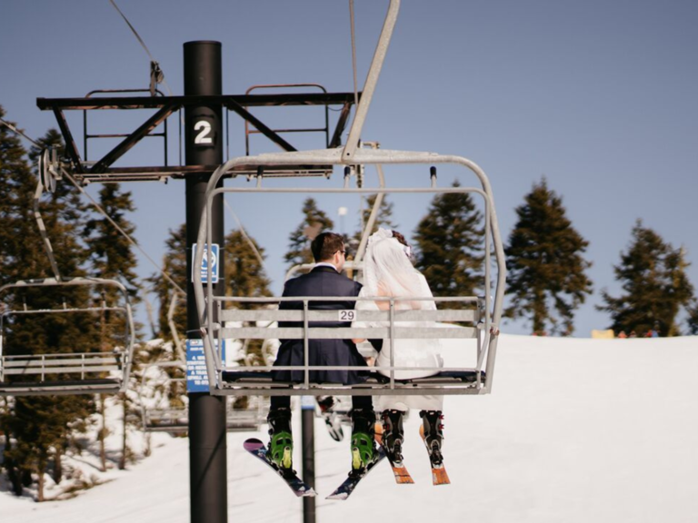 Bride and groom on ski lift 