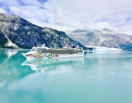 Cruise ship passing mountains