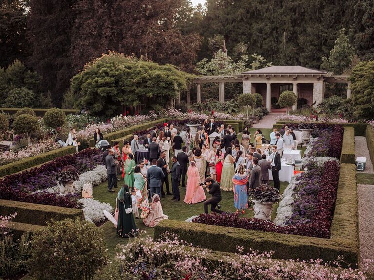 Guests mingling at outdoor whimsical garden wedding