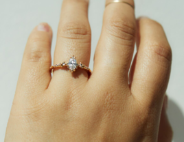 Marquise diamond center stone with round and rose cut diamonds on gold band