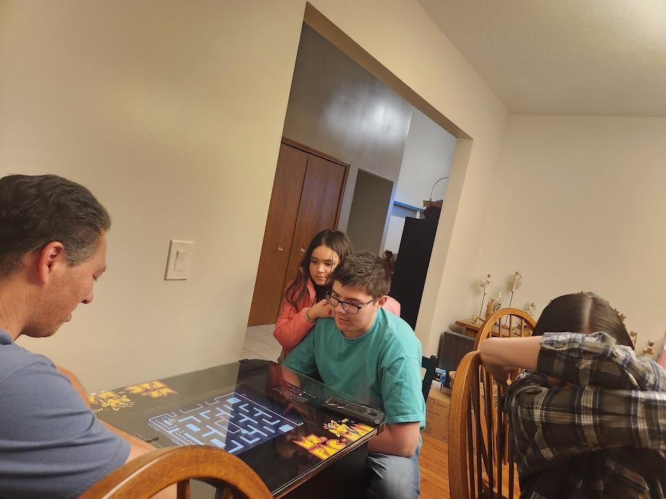 Family dinner night at Mike's house playing Pac Man and Uno.