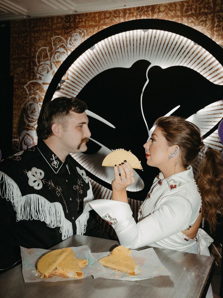 Couples dramatic wedding photo eating tacos in Las Vegas