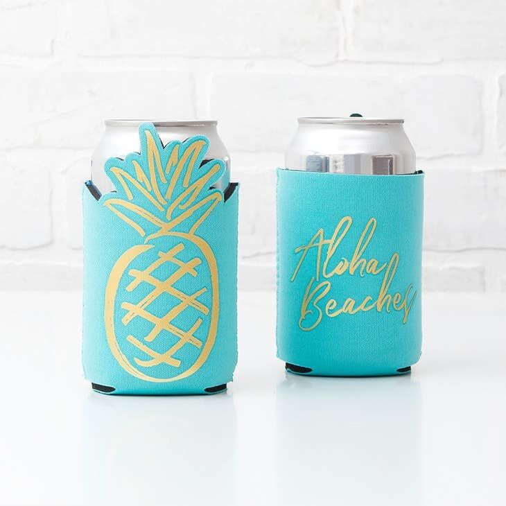 Blue beer cozies with a gold engraving of a pineapple and saying