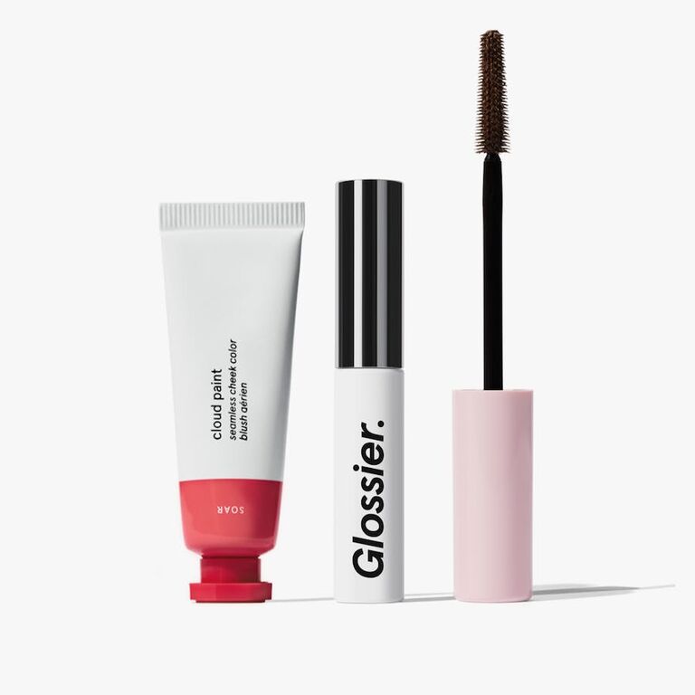 A makeup set from Glossier with cheek paint, mascara, and an eyebrow groomer