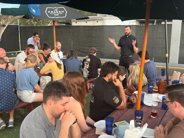 Samantha and Joel both attended Theology on Tap at a brewery in Sarasota. Little did they know, these seemingly small events would lead to their eventual meeting. This is a photo that was taken at the event with both of them there before they met. 