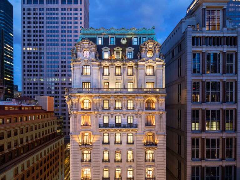 St. Regis Hotel exterior at dusk all lit up in nyc