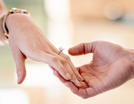 Woman's hand wearing engagement ring