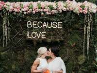 'Because Love' neon sign in simple type with couple kissing underneath