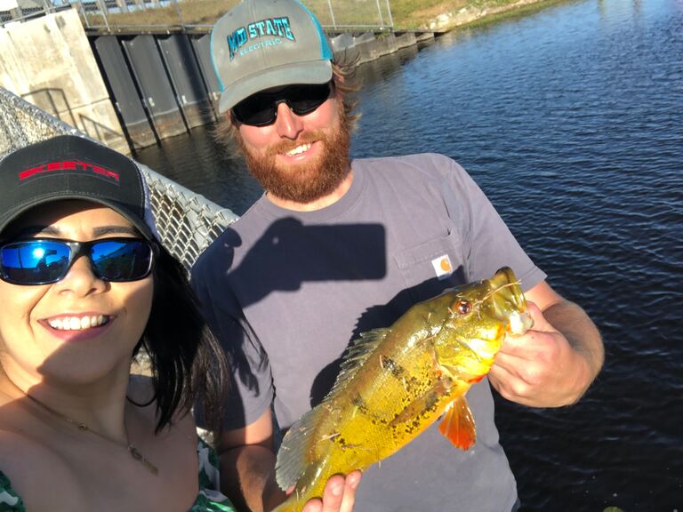 Our first picture, the first time  Drew took me fishing. Caught my first peacock bass! 