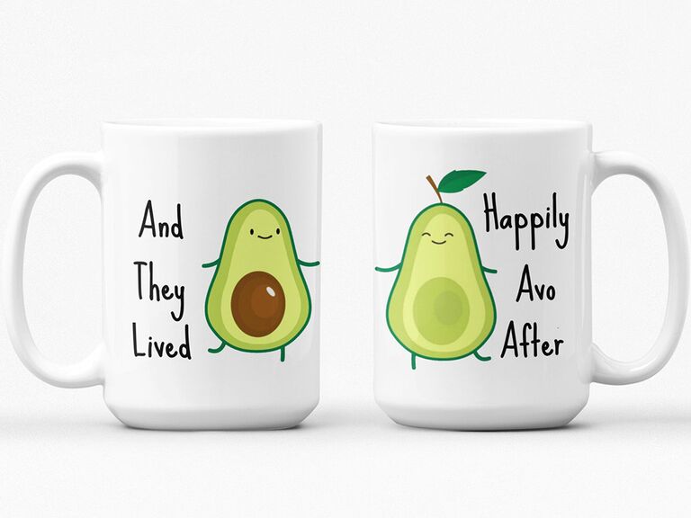 White coffee mugs with avocado graphics and 'And they lived' 'Happily ever after' in black type