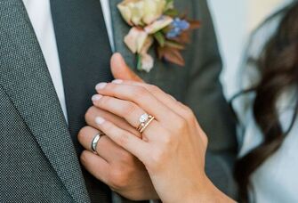 Bride with a diamond engagement ring and groom with wedding ring