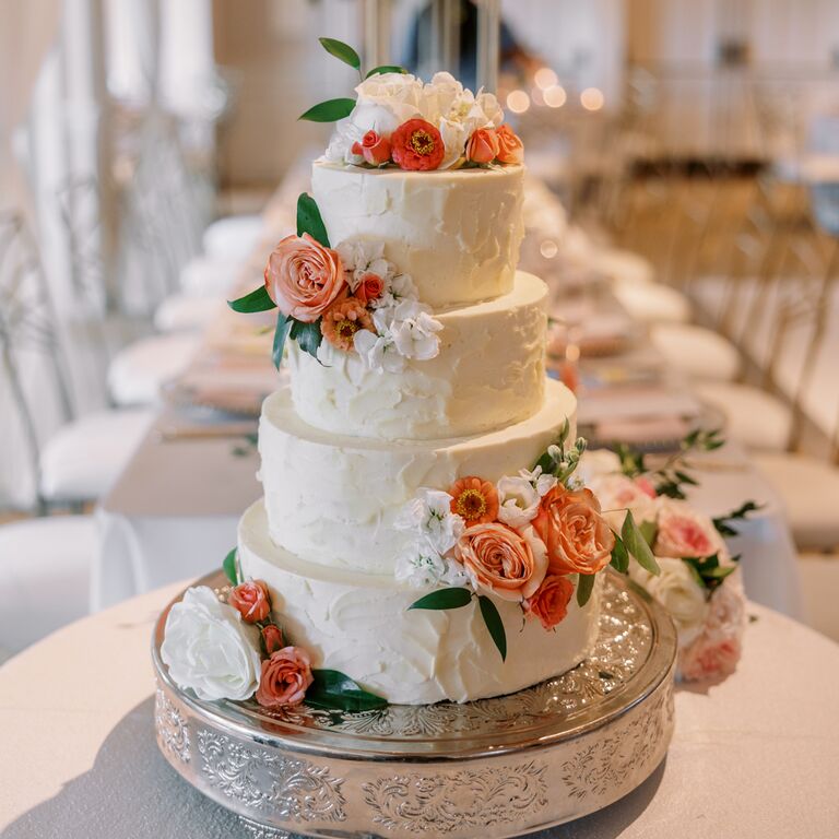 White buttercream wedding cake with fresh flowers