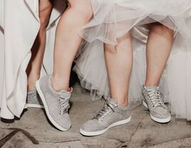 Brides wearing sparkly wedding sneakers on wedding day