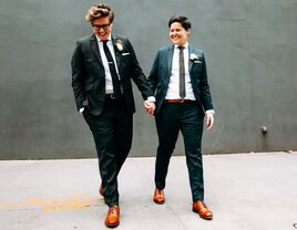 Same sex couple wearing gender neutral wedding attire