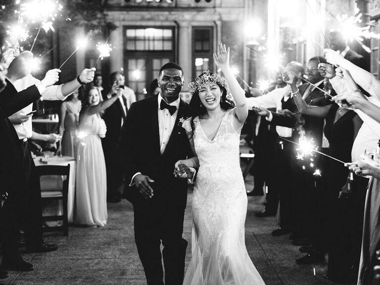 Bride and groom exiting wedding reception with sparklers