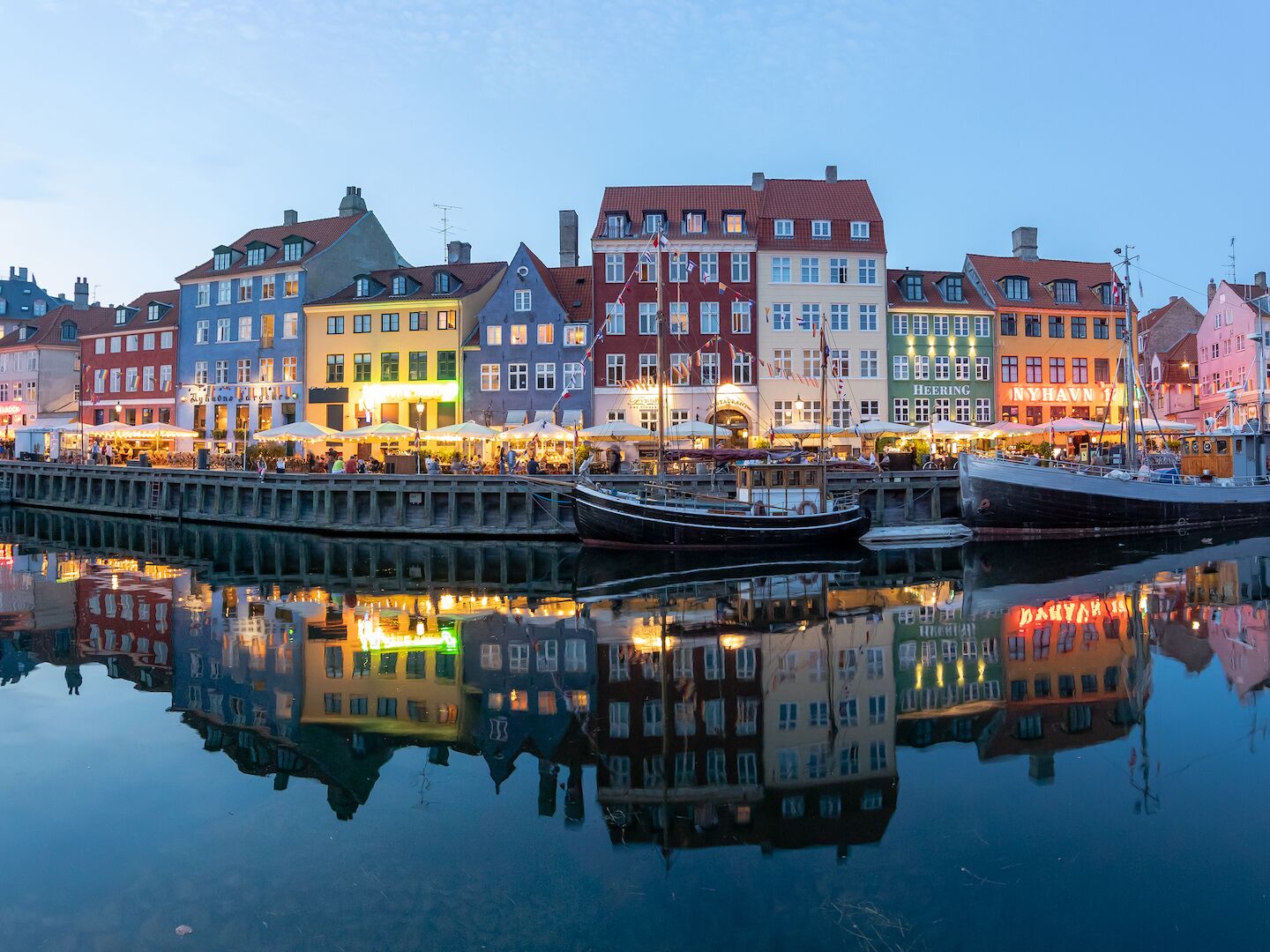 View of illuminated buildings in city of Copenhagen against sky,Nyhavn,Denmark