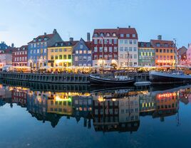 View of illuminated buildings in city of Copenhagen against sky,Nyhavn,Denmark