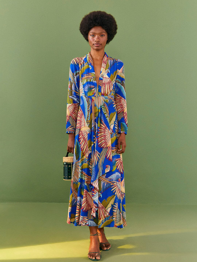 A model shows off this breathtaking wedding guest dress in a blue bird and fern print.