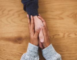 Couples holding hands on a table