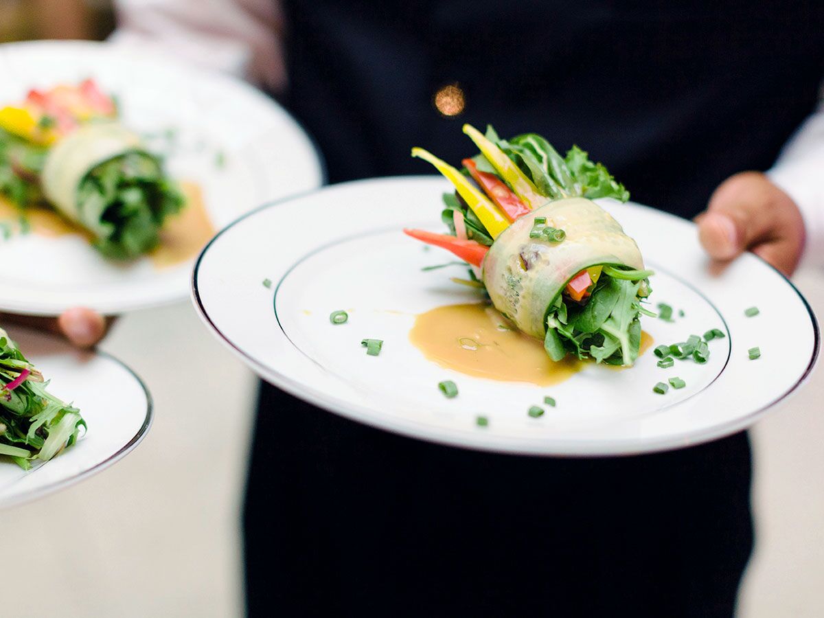 server holding plate with salad