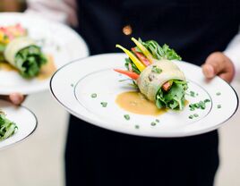 server holding plate with salad