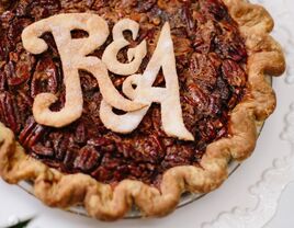 Pecan pie featuring couple's initials as decoration. 