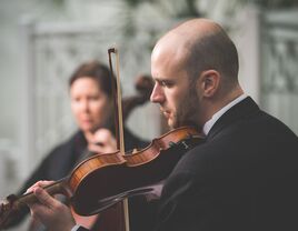 Man playing violin wedding songs