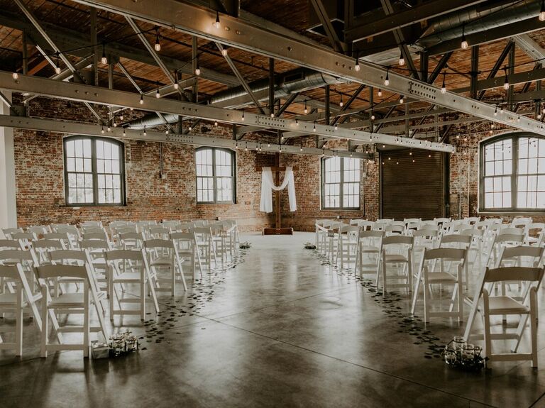 Indoor ceremony space with red brick walls