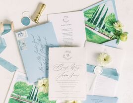 White wedding invitations with blue envelopes and white wax seals