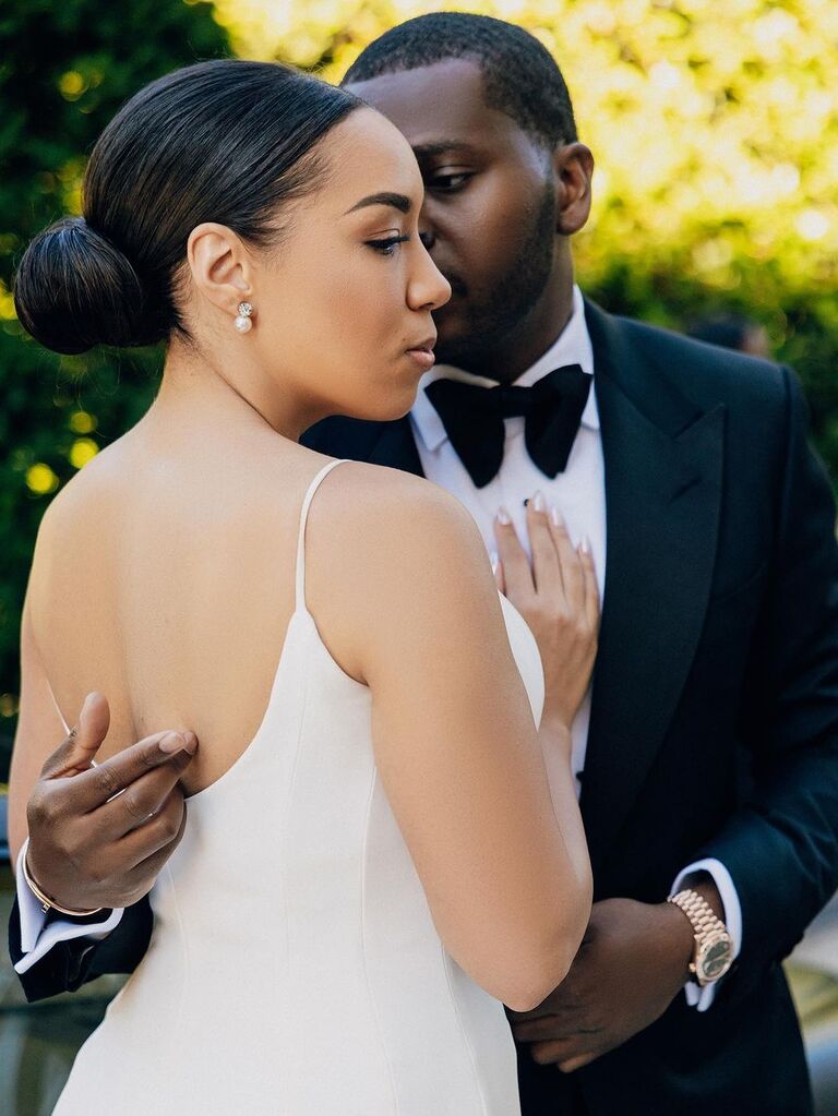 Slicked back low bun wedding updo for long hair