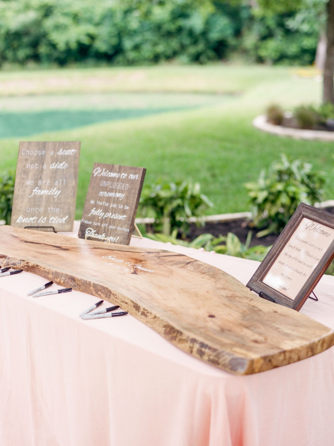 Plank of wood sitting on table for guest book