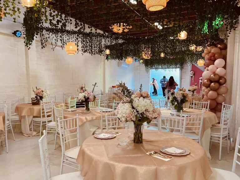 Beautiful event space adored with lush greenery and pink florals. 