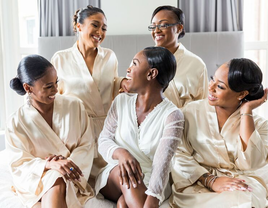 bride and bridesmaids posing for getting-ready pictures in bridal party robes