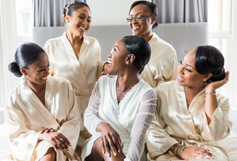 bride and bridesmaids posing for getting-ready pictures in bridal party robes